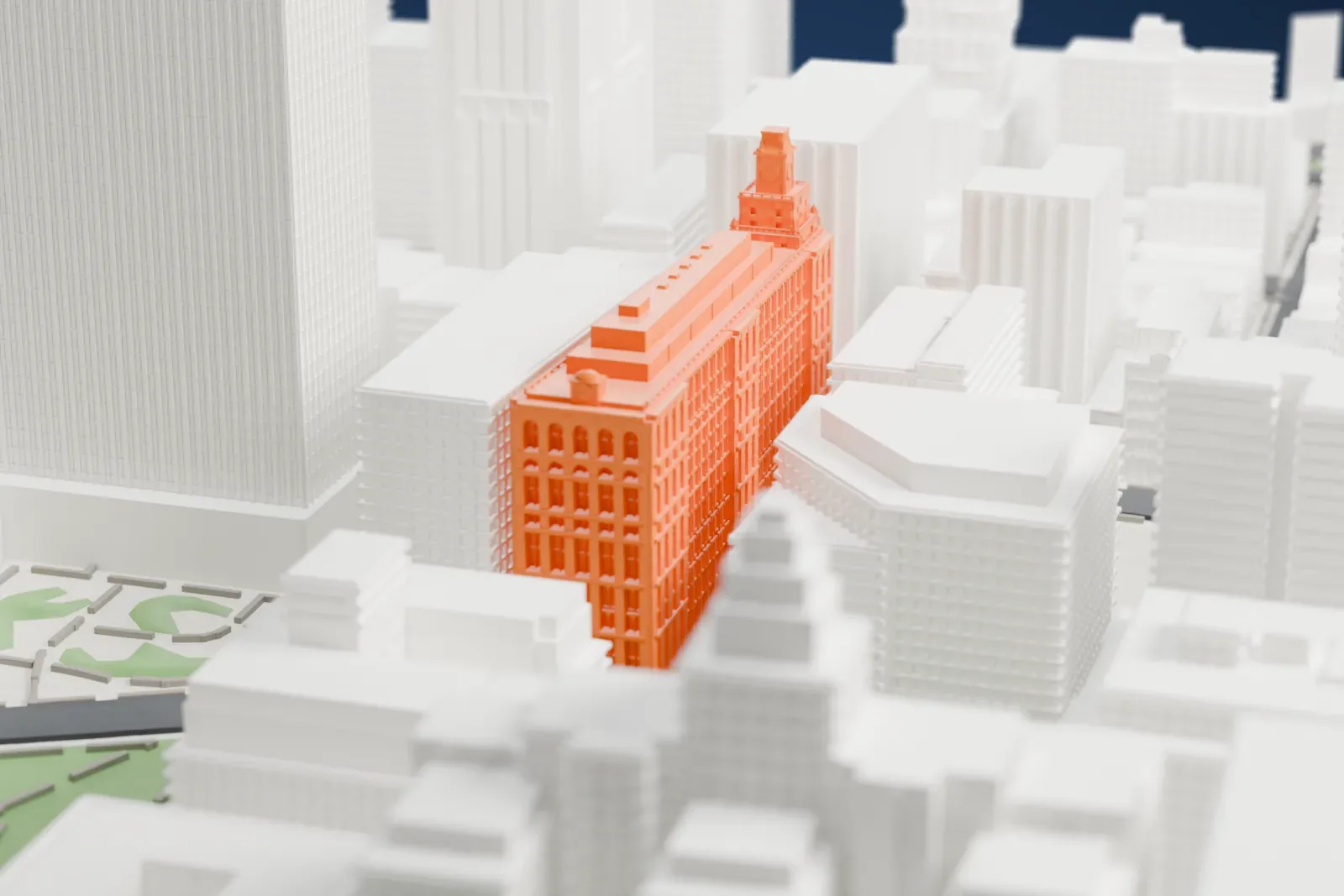 A white 3D print of 108 Leonard, a long, narrow building with rows of arched windows and a small clock tower, hemmed in by taller buildings.