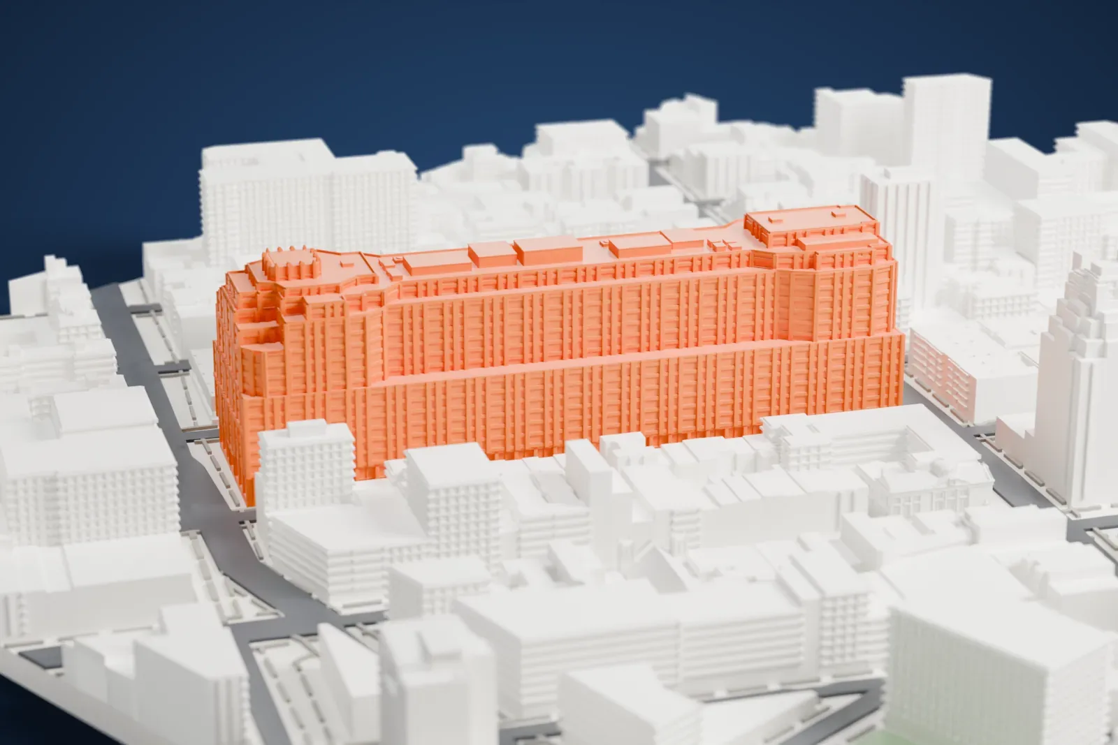 A white 3D print of 111 Eighth Avenue, a very long stepped building filling a city block, surrounded by lower buildings, streets and small green spaces.