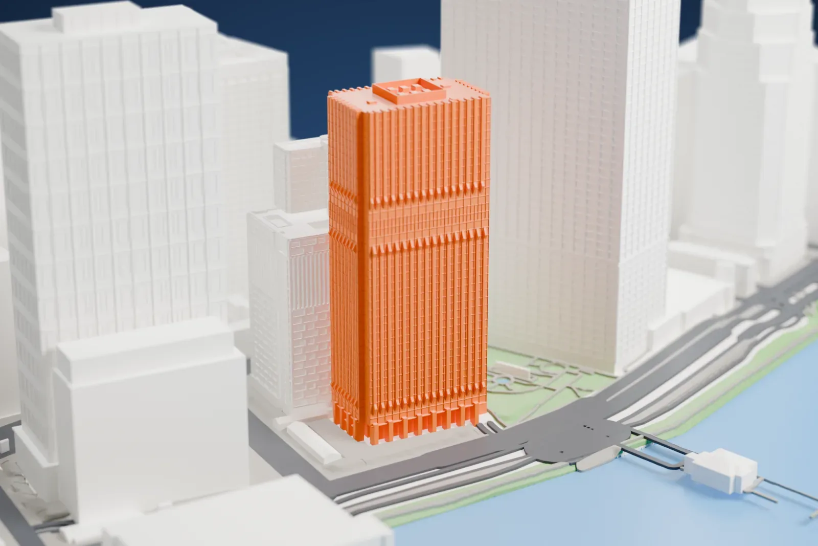 A white 3D print of the 125 Broad Street tower beside a small park and the water's edge, with taller buildings around it.