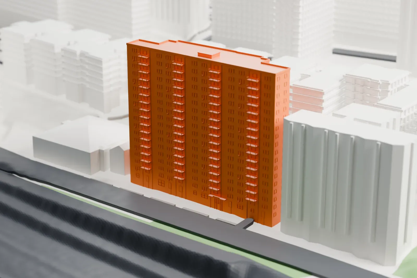 A white 3D print of 1520 Sedgwick Avenue, a tall apartment building beside lower apartment blocks, a wide road and a river.
