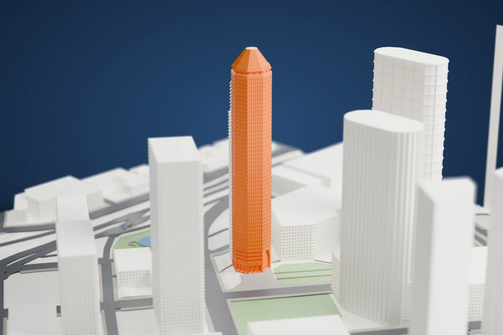 A white 3D print of 1600 Smith Street, a tall tower with a faceted, pyramid-shaped crown, standing among the surrounding streets and buildings.