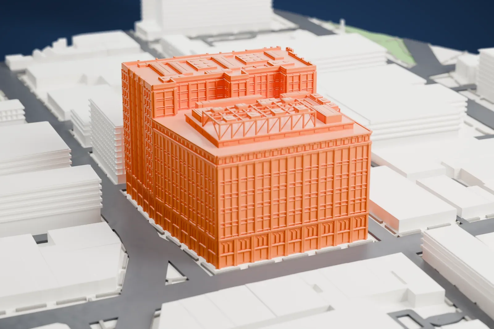 A white 3D print of 165 Halsey Street, a large block-filling tower with a gridded facade and a roof of boxes and steel framing, among lower buildings and streets.