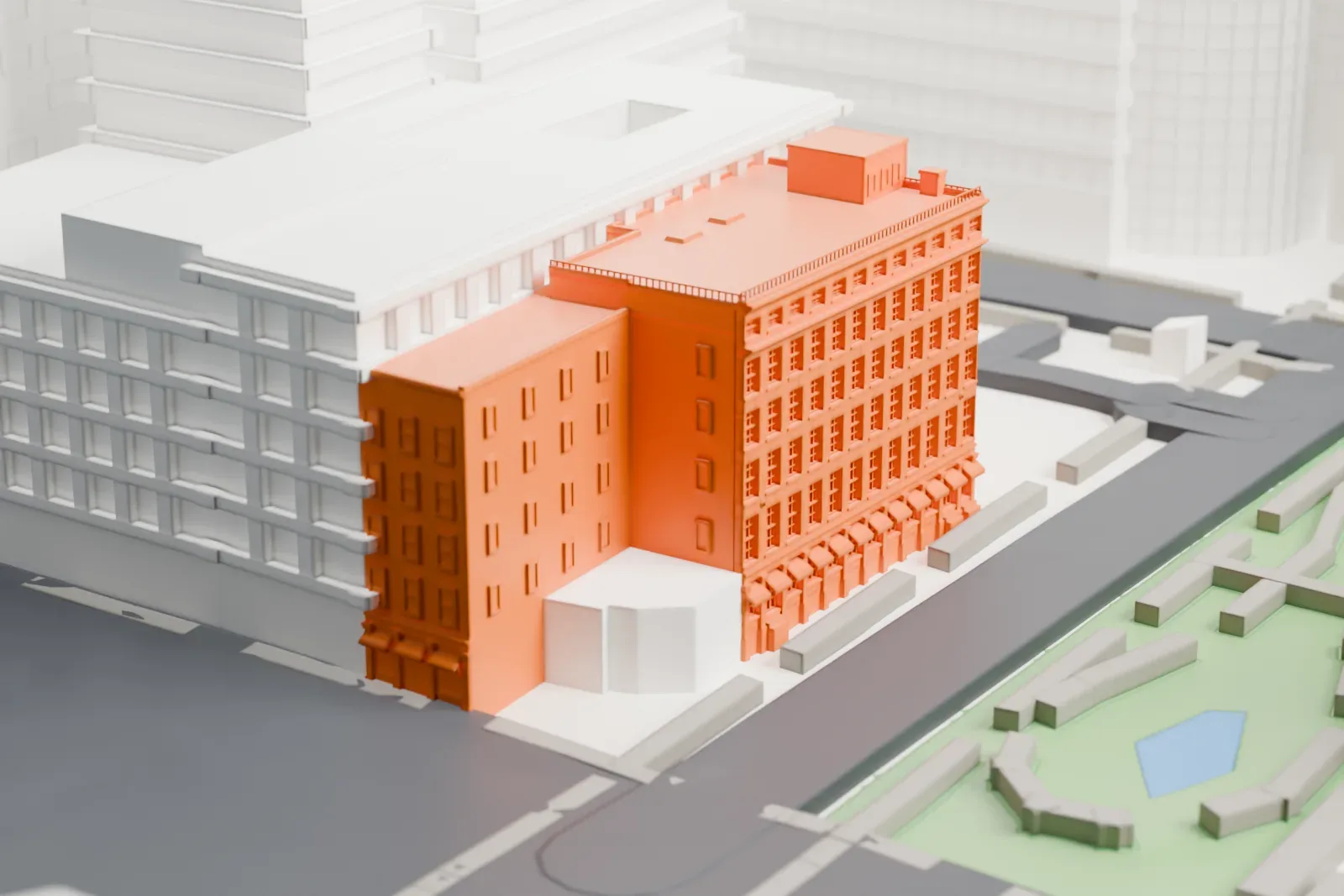 A white 3D print of 170-176 John Street, a six-story building with a detailed cornice and rows of windows, next to taller buildings and a small park with a pond.