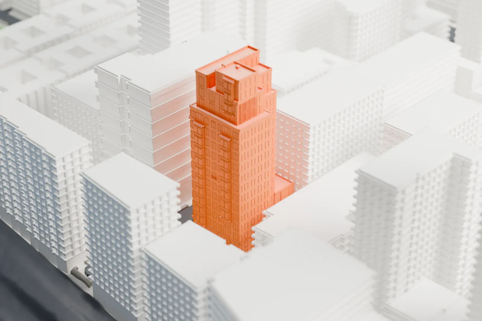 A white 3D print of 20 East End Avenue, a tall tower with a stepped crown among other buildings, with water beyond the city edge.