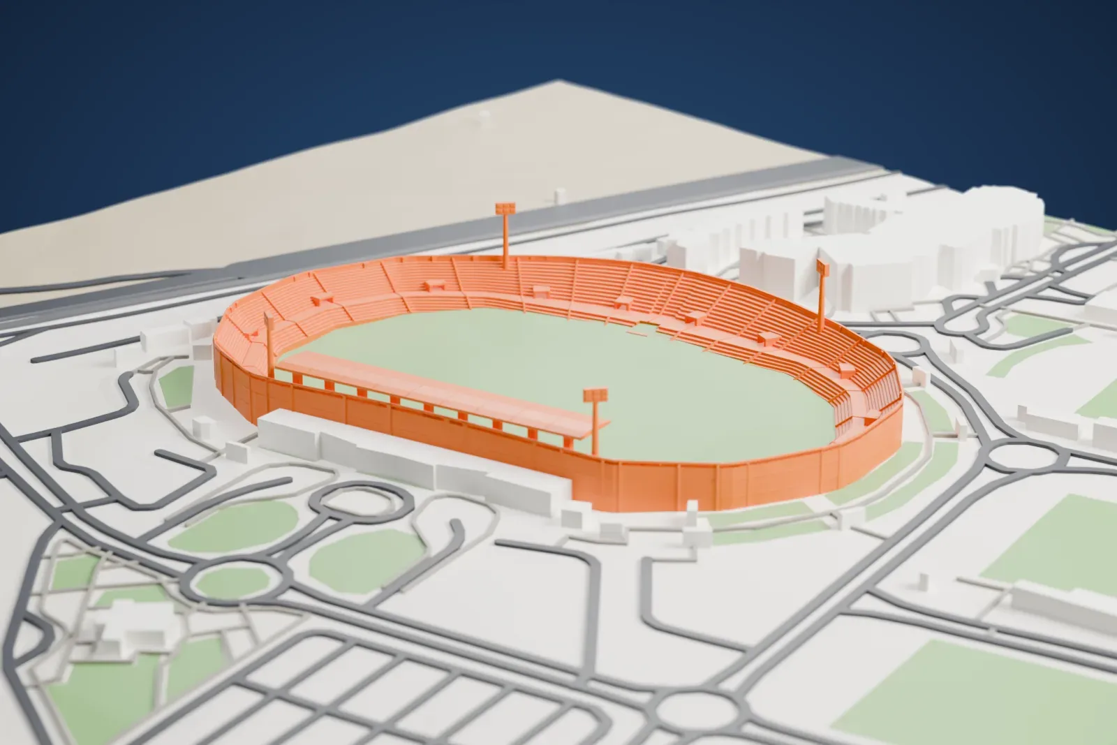 A white 3D print of the 30 June Stadium, a wide stadium bowl with stands around a central pitch, set among the surrounding streets and buildings.