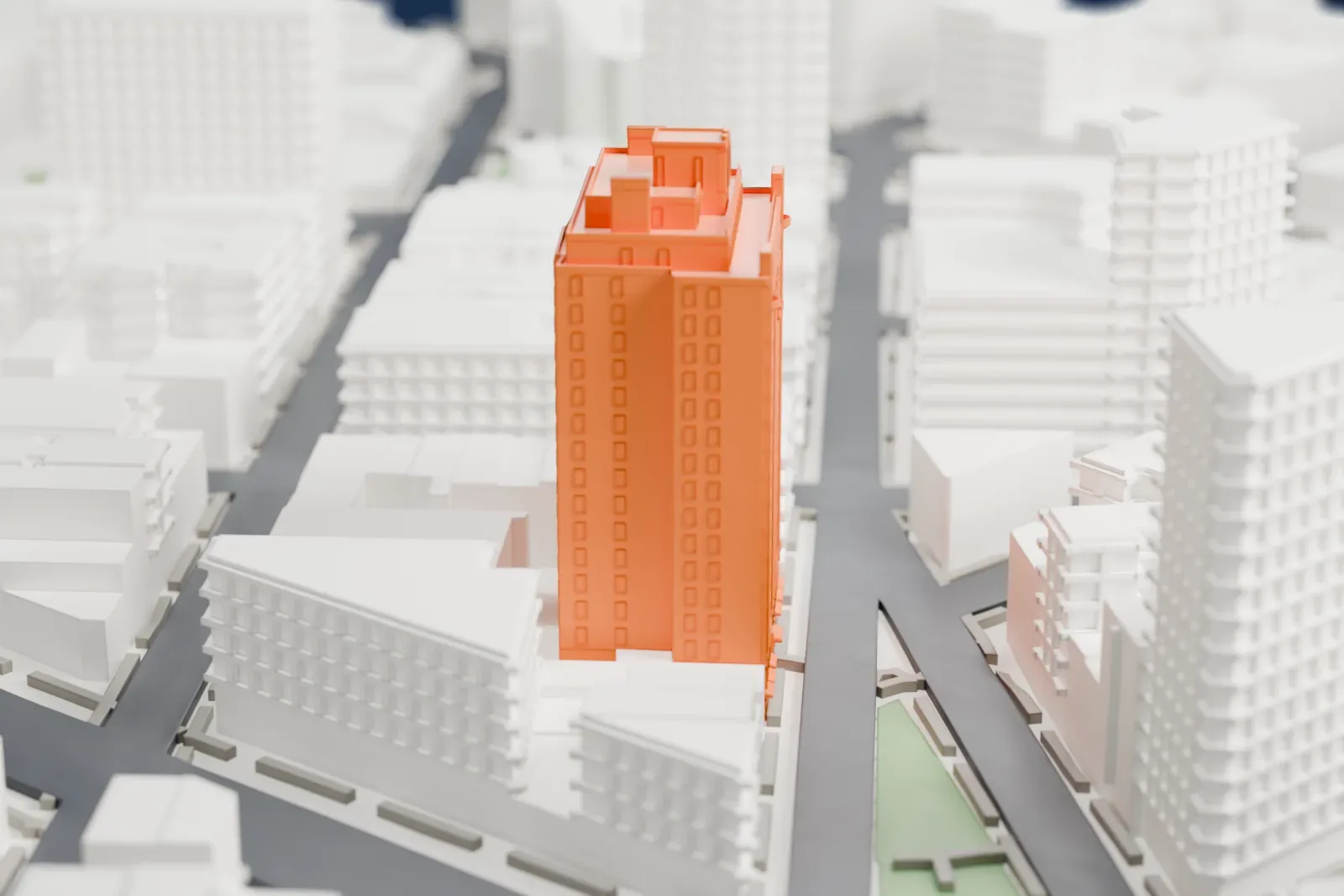A white 3D print of 45 Christopher Street, a tall residential tower with a stepped crown, standing among lower buildings with a small green park nearby.