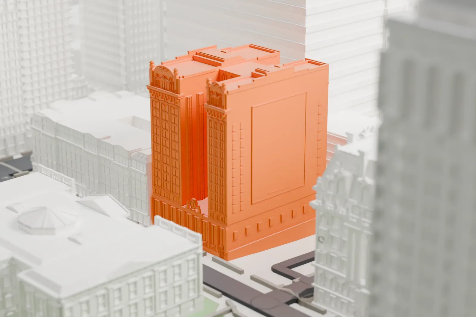 A white 3D print of 49 Chambers, a tall building whose upper floors split into two towers, among older and taller buildings and a street below.