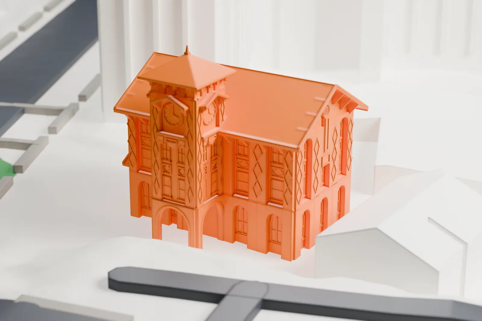 A white 3D print of the 52nd Police Precinct Station, a three-story brick building with a clock tower and a steep gabled roof, beside streets and green slopes.
