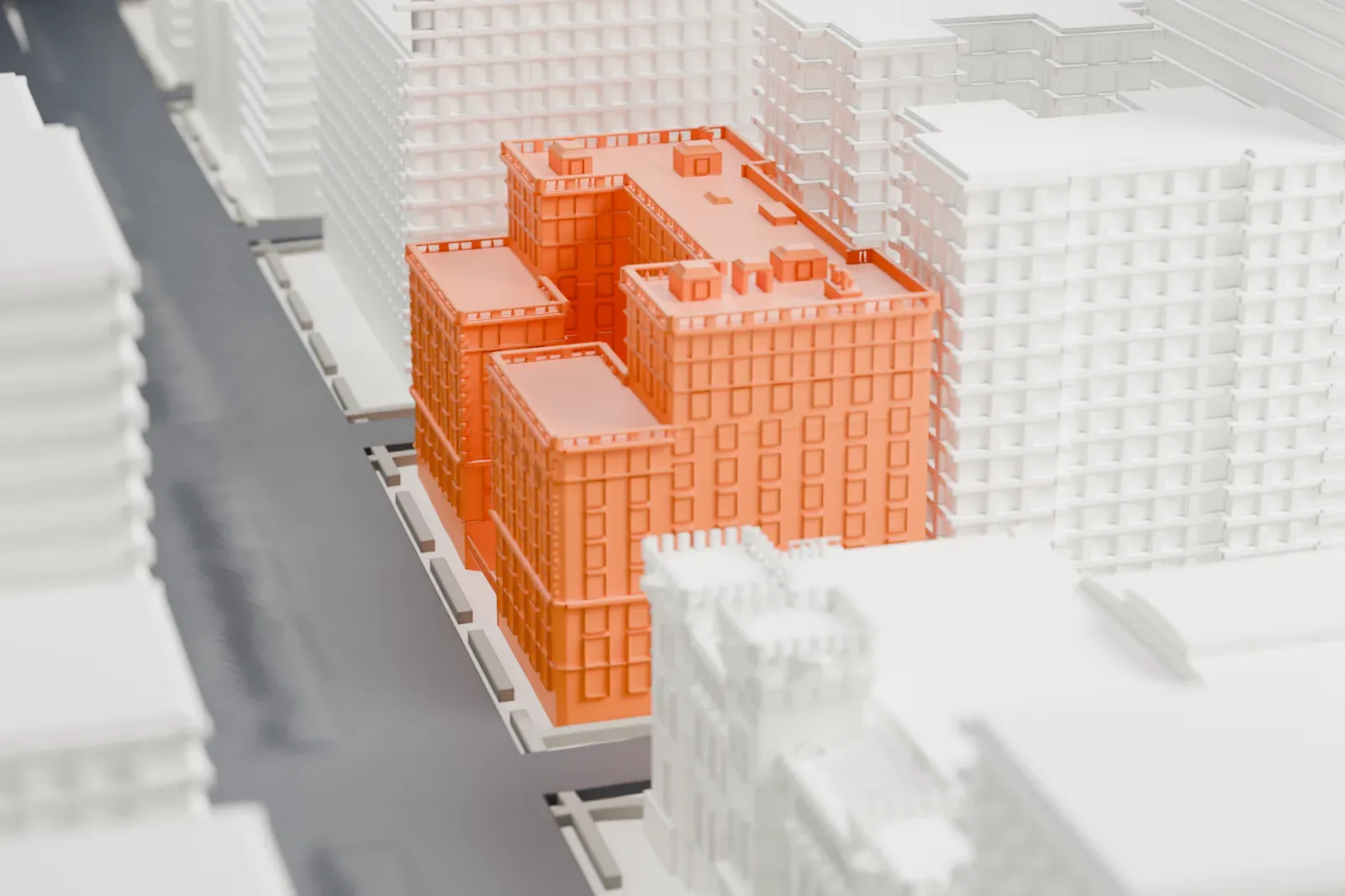 A white 3D print of 655 Park Avenue, a stepped block of several wings with rooftop details, hemmed in by taller neighboring buildings along a narrow street.