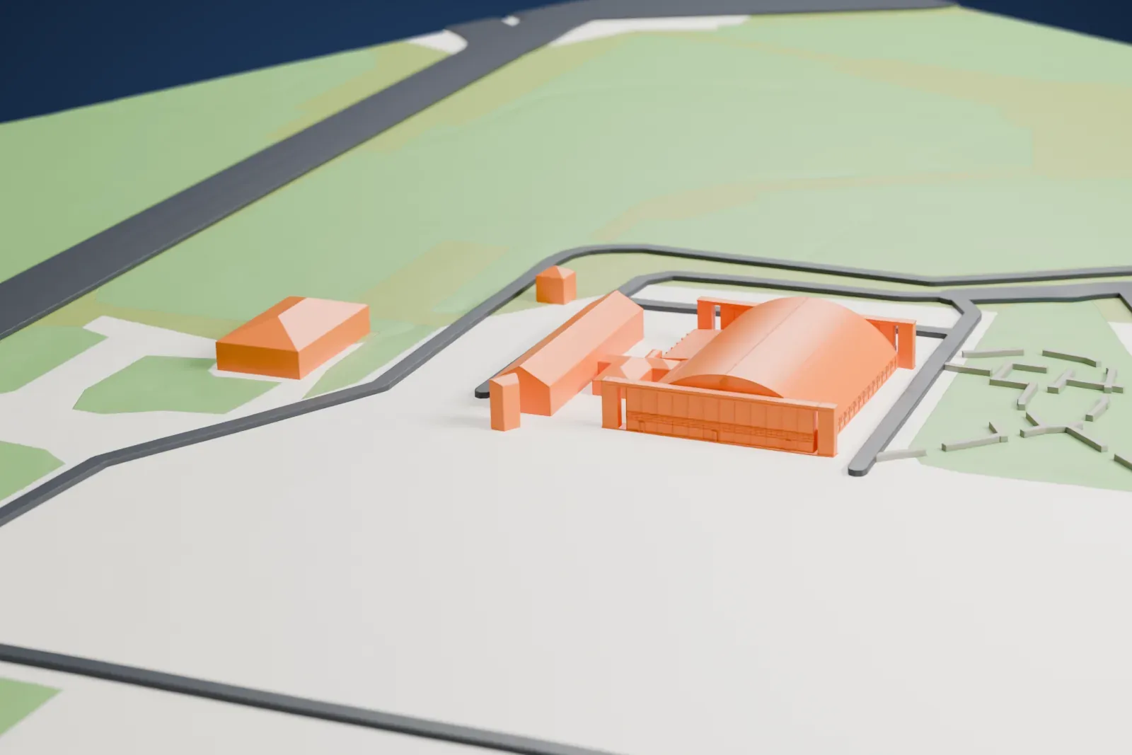 A white 3D print of Hangar 1301, a long hangar with a curved roof and tall end walls, on flat ground with grass, roads and a few small buildings nearby.