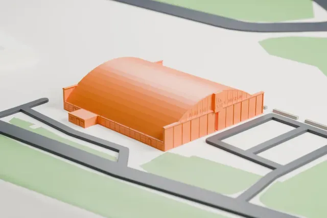 A white 3D print of the Airline History Museum Hangar 9 model in Kansas City, with the streets around it.