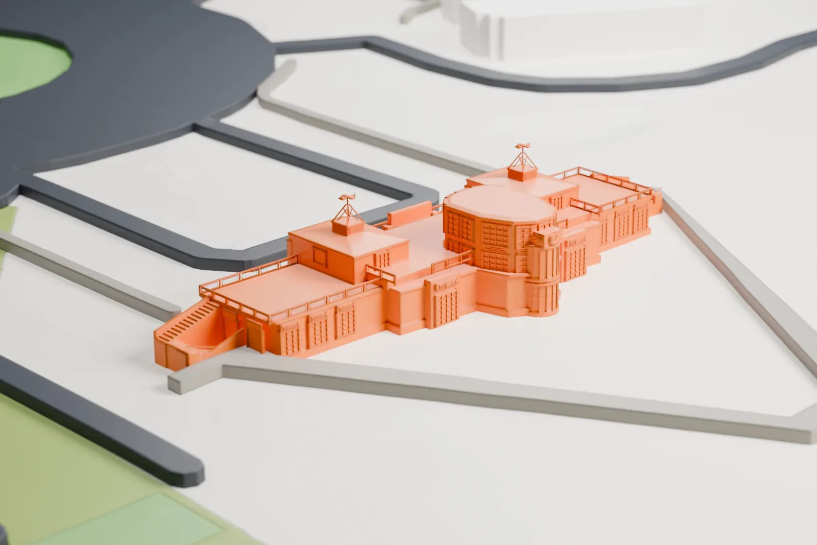 A white 3D print of the Akron Fulton Airport Administration Building, with a central tower and long wings beside looping roads and open ground.