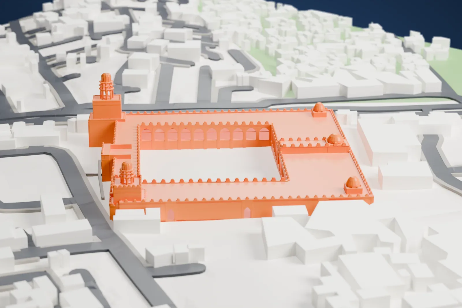 A white 3D print of the al-Hakim Mosque, a rectangular courtyard ringed by arcades, with two minarets at the front and small domes at the corners, among low buildings and streets.