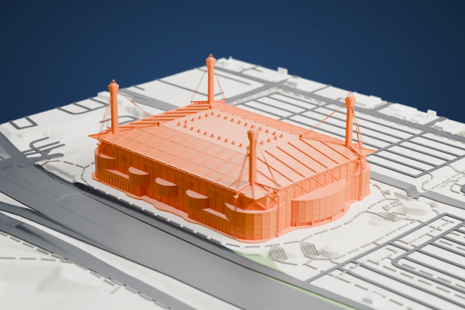 A white 3D print of the Alamodome, a stadium with a broad roof and four tall corner masts with diagonal cables, surrounded by wide roads and open paved ground.