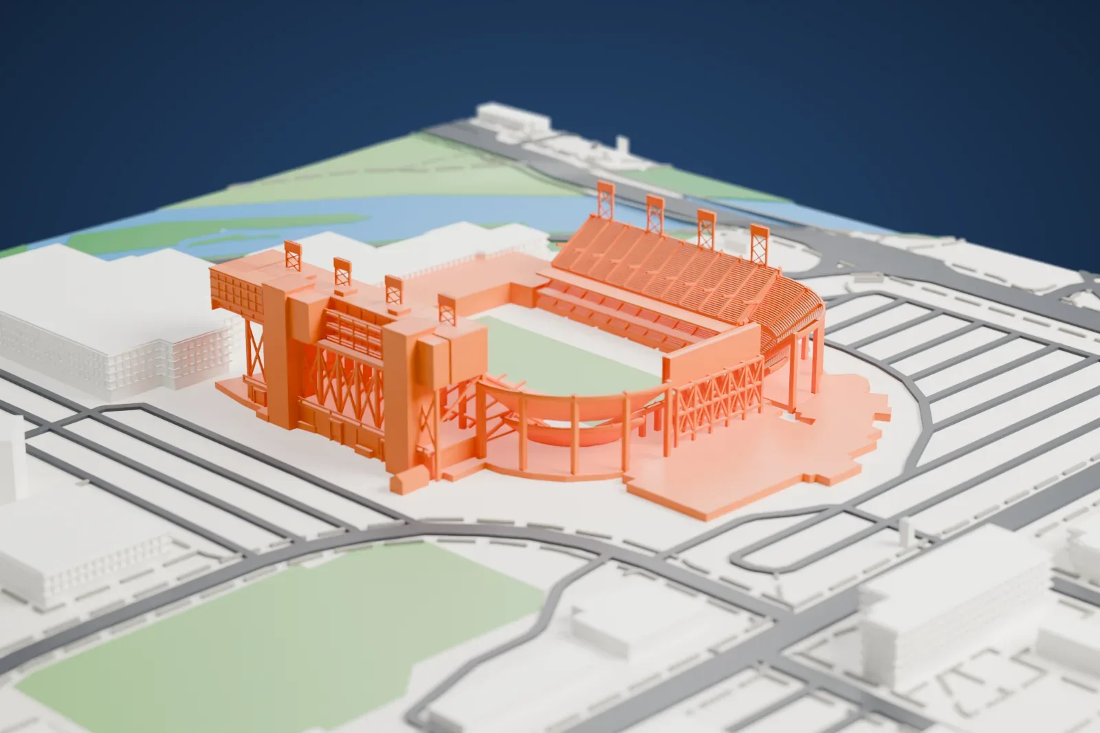 A white 3D print of Albertsons Stadium, a horseshoe-shaped football stadium with tall grandstands, lattice light towers and a green field, beside a river, roads and campus buildings.