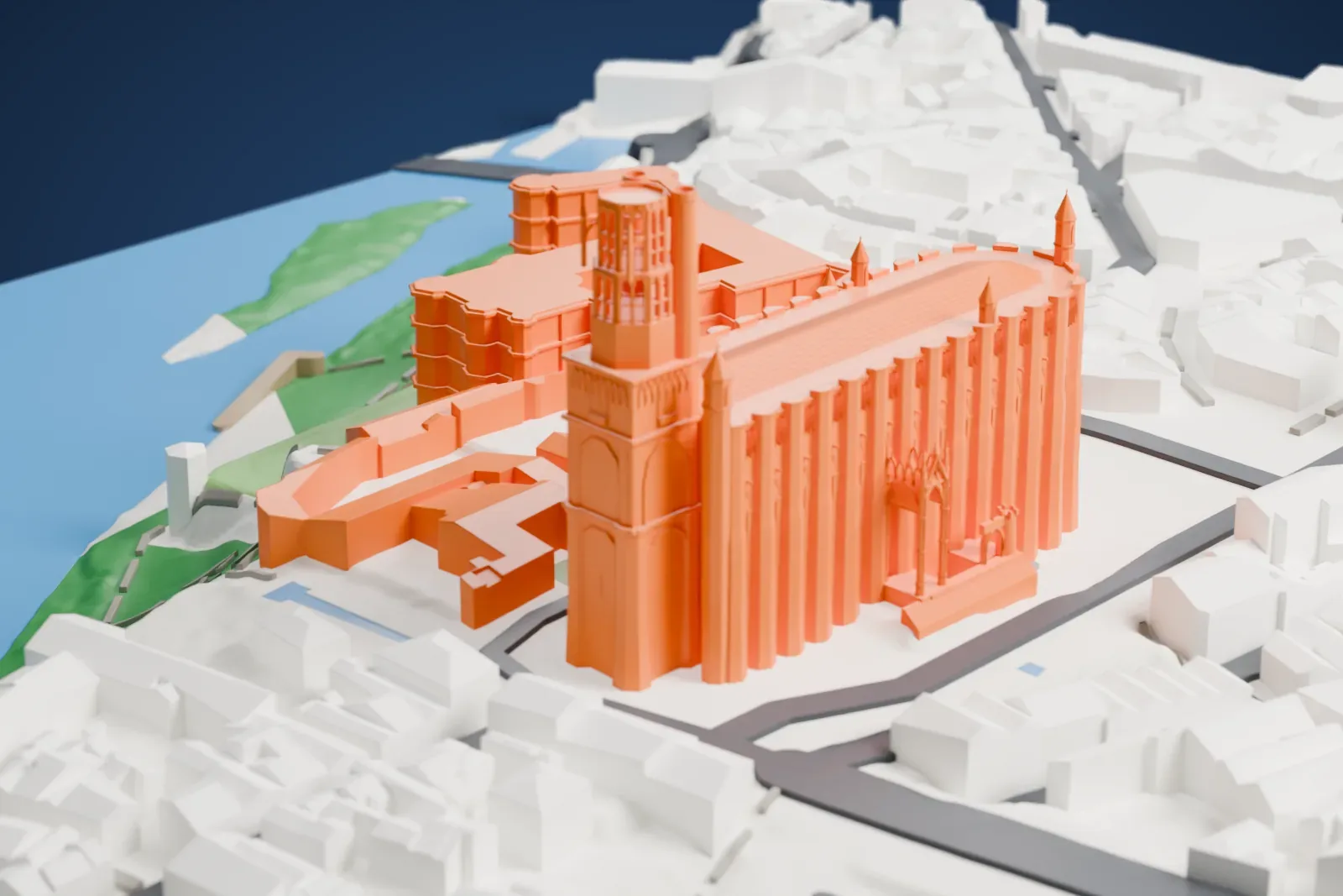 A white 3D print of Albi Cathedral, a long buttressed nave with a tall bell tower at one end, surrounded by narrow streets and closely packed buildings.