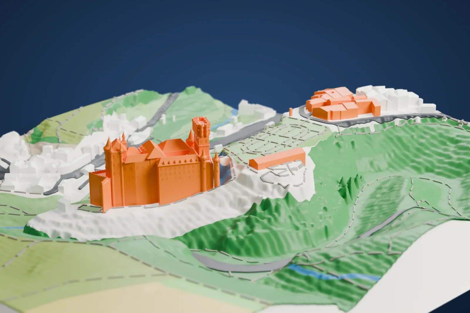 A white 3D print of the Alcázar of Segovia, a castle with a tall battlemented tower and slender pointed turrets, perched on a steep green hillside above a valley.