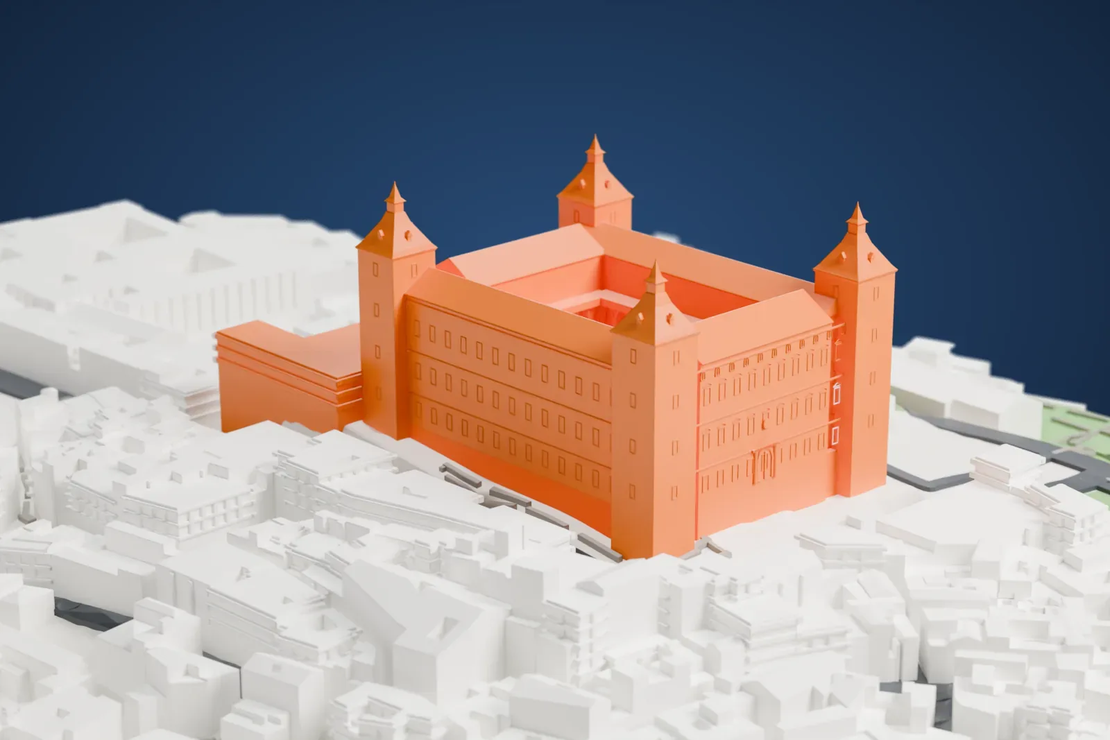 A white 3D print of the Alcázar of Toledo, a square fortress with four corner towers topped by spires, surrounded by dense buildings, streets and green slopes.