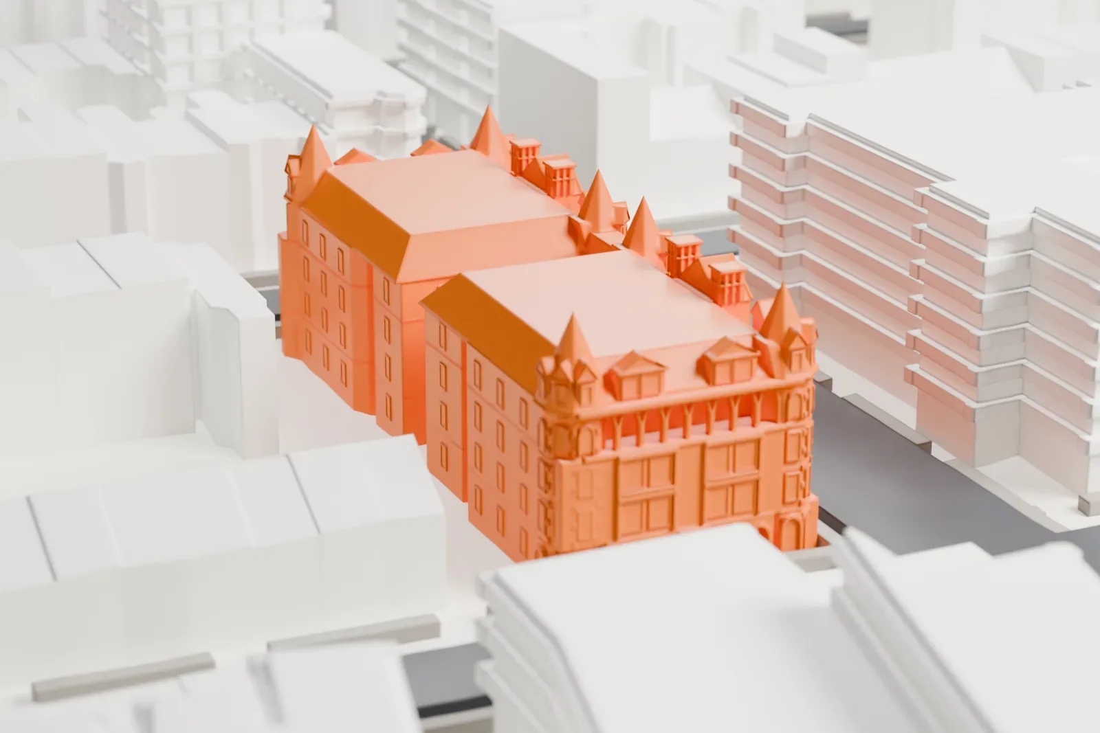 A white 3D print of the Alhambra Apartments, a large building with pointed corner towers and gables, set among streets and neighboring buildings.