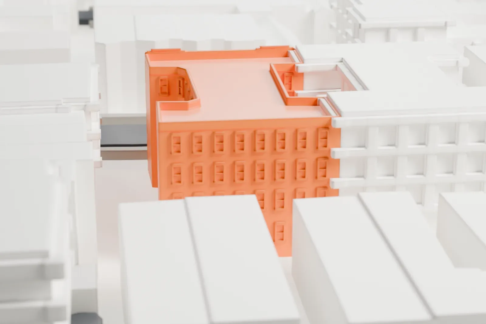 A white 3D print of Alku and Alku Toinen, a brick apartment block with fire escapes on its front, set among similar buildings on city streets.