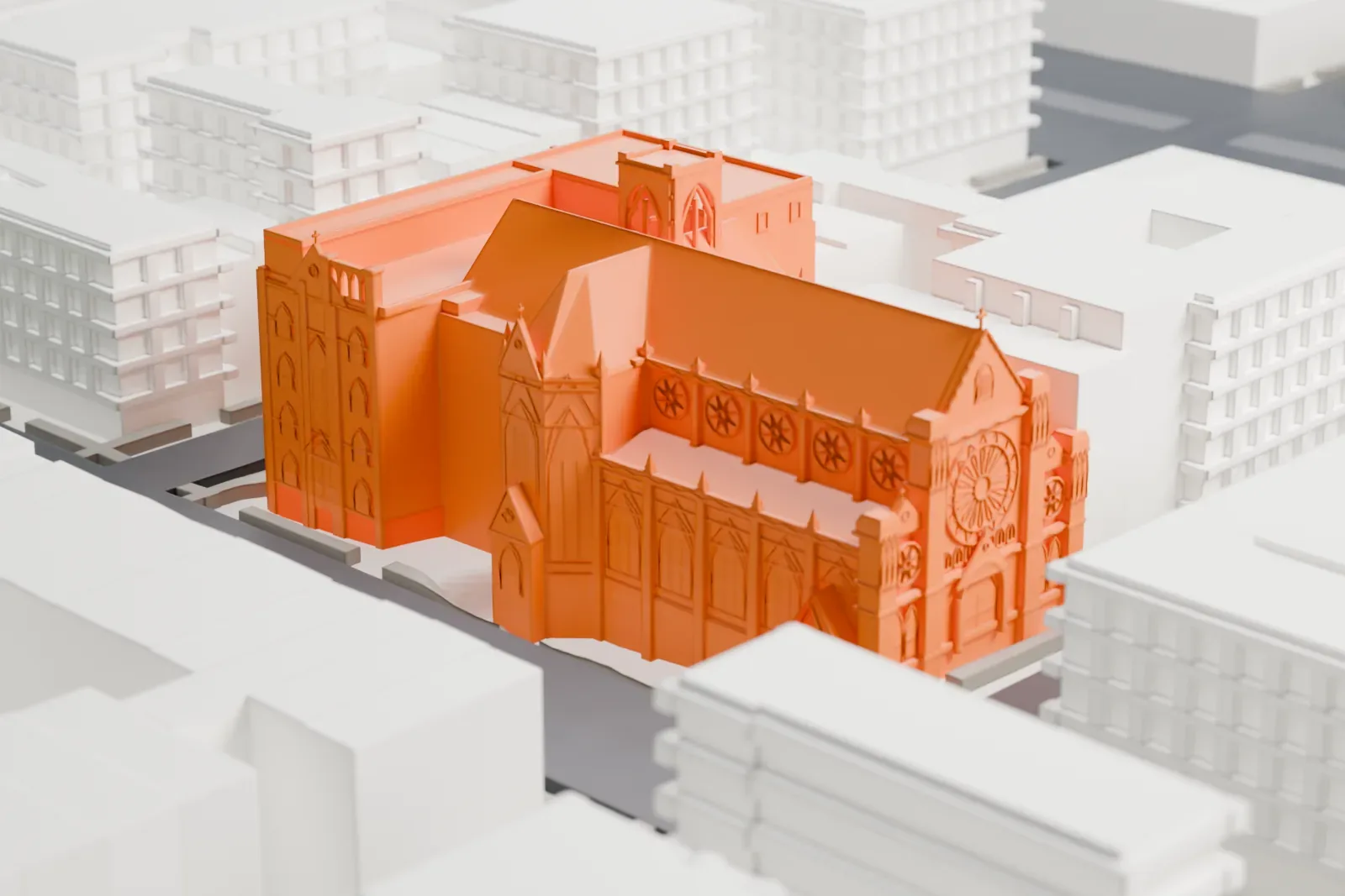 A white 3D print of All Saints Church and its school wing, with steep church roofs and a tower, standing on a street corner with an open green space nearby.