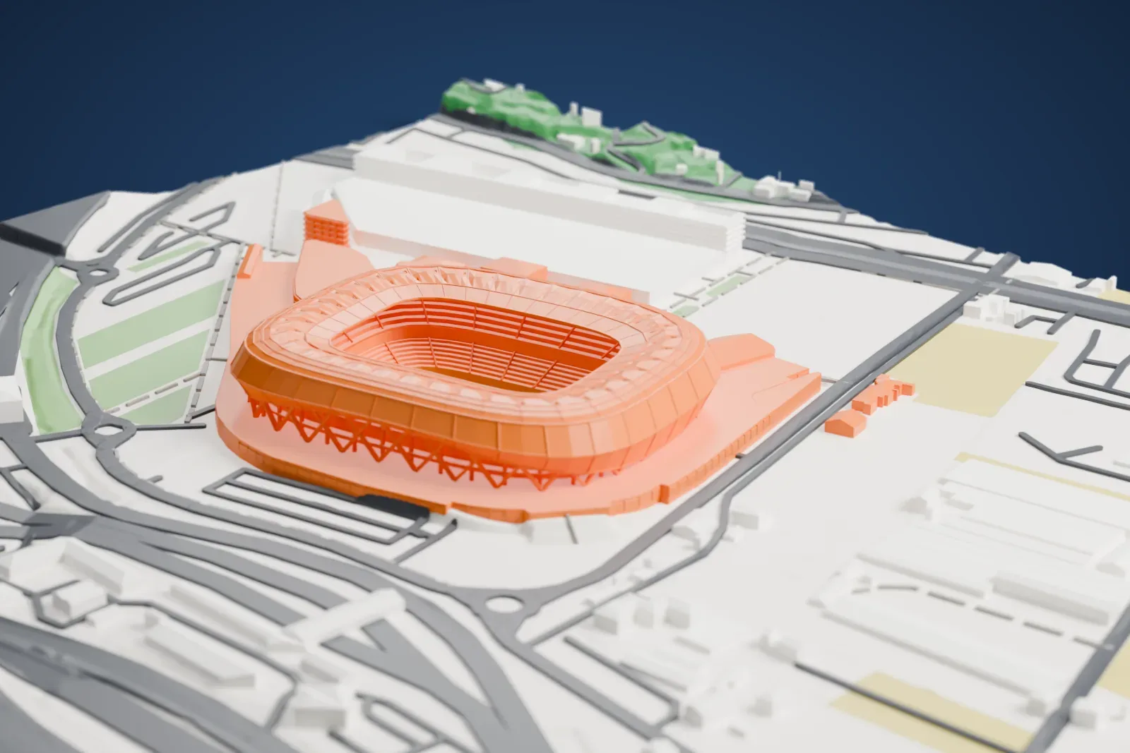 A white 3D print of Allianz Riviera, an oval stadium with a wide ring-shaped roof, angled supports around its base and a long low wing beside it, among roads and low buildings.