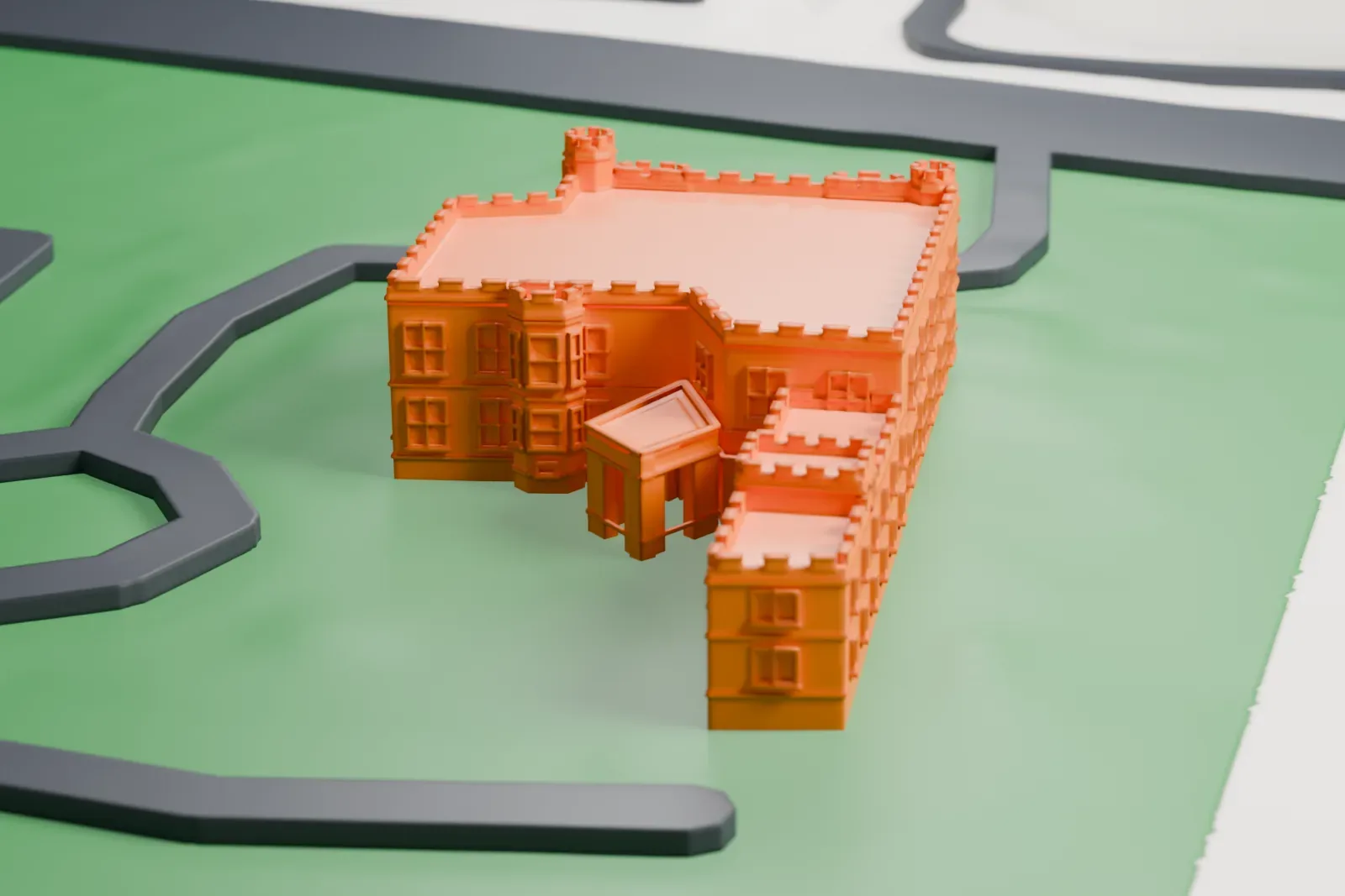 A white 3D print of Alnwick Hall, a castle-style manor with battlemented roofs and corner turrets, on a green lawn with curving drives.
