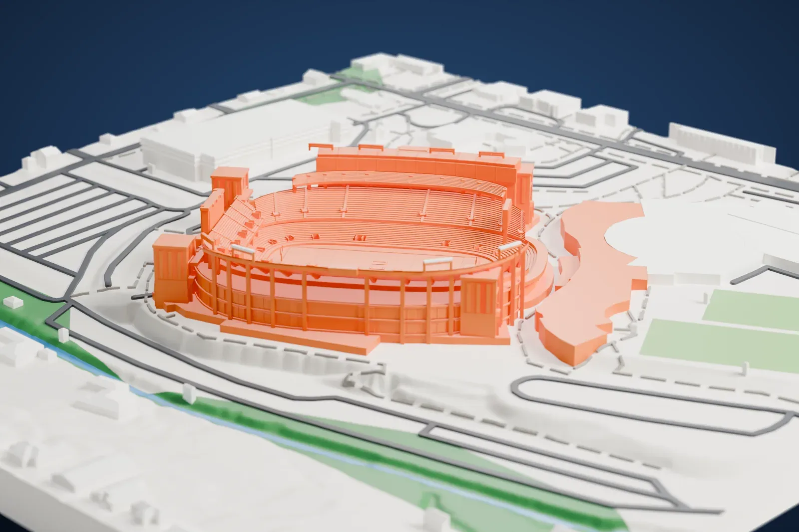 A white 3D print of Amon G. Carter Stadium, an open bowl of stepped seating with arched entrance fronts and tall corner towers, surrounded by roads, grass fields and large low buildings.