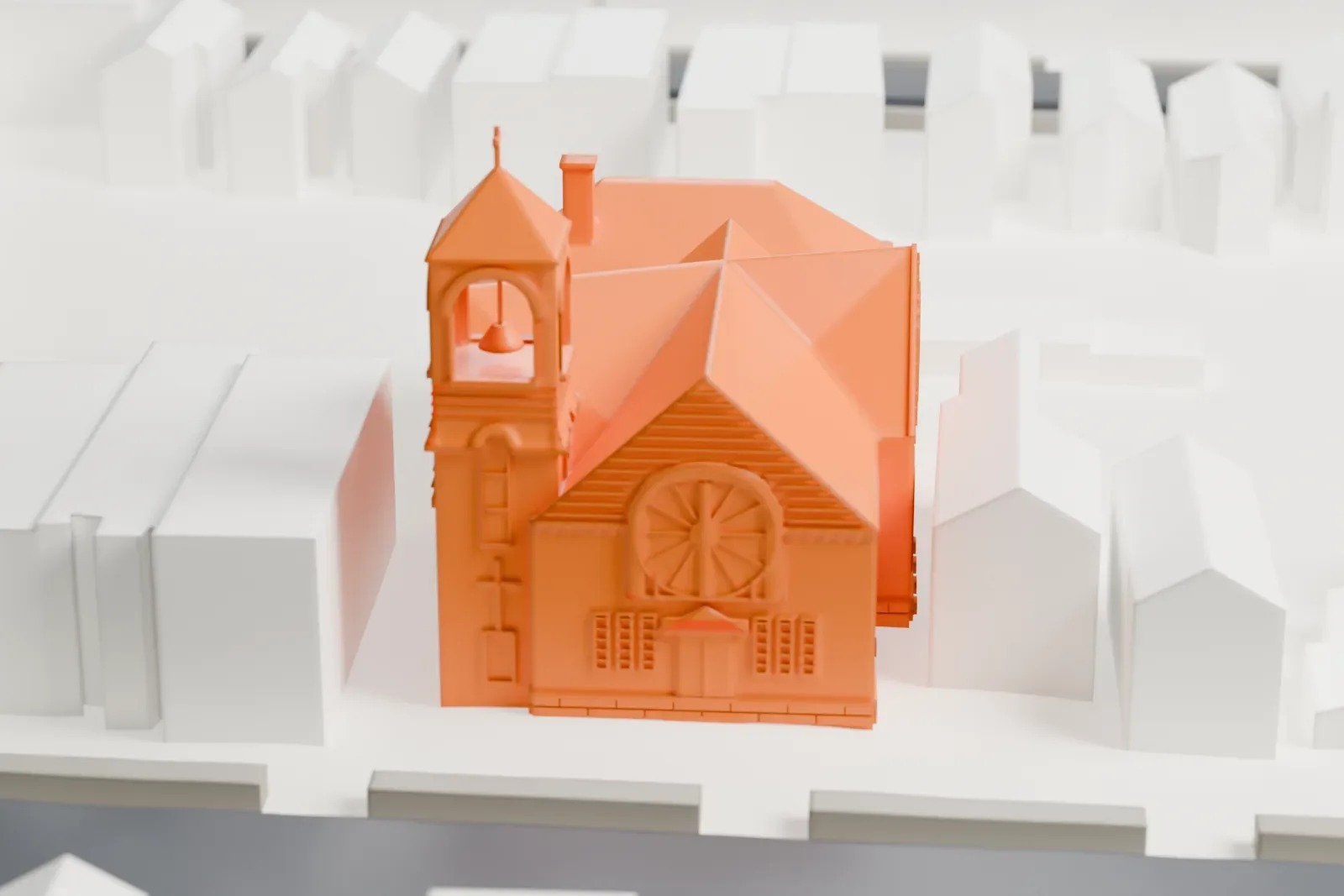 A white 3D print of Andrews United Methodist Church, a brick church with a square bell tower and several hipped and gabled roofs, among rows of smaller buildings.