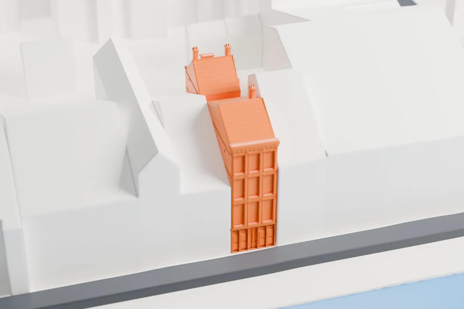 A white 3D print of the Anne Frank House, a narrow canal house with tall windows and a steep roof with small chimneys, and a second roofed building behind it, squeezed between taller buildings beside a canal.
