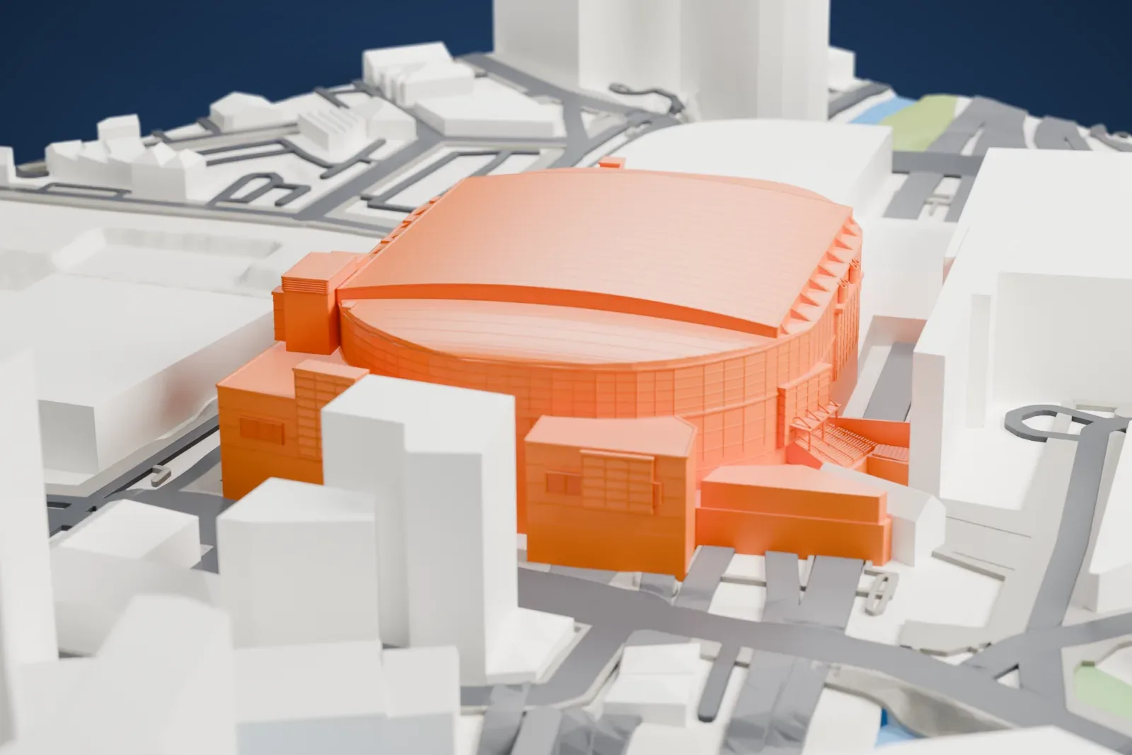 A white 3D print of AO Arena, a large indoor arena with a broad curved roof, surrounded by bigger buildings, streets and railway lines.