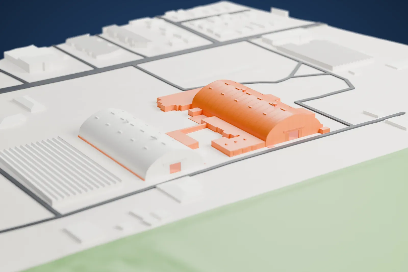 A white 3D print of the Archerfield Second World War Igloos Complex, a group of long barrel-roofed hangars joined by low connecting buildings, set on open ground between roads and large flat-roofed sheds.
