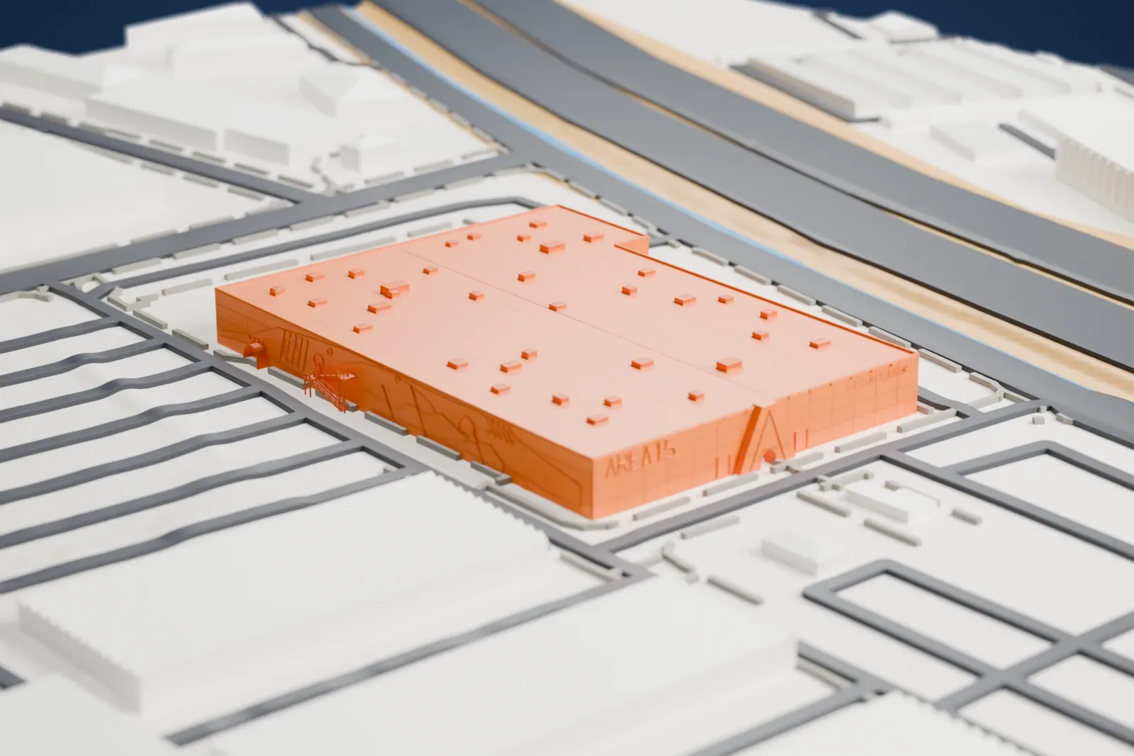 A white 3D print of AREA15, a wide, low building with lettering on its facade and small units across a flat roof, surrounded by roads and a channel.