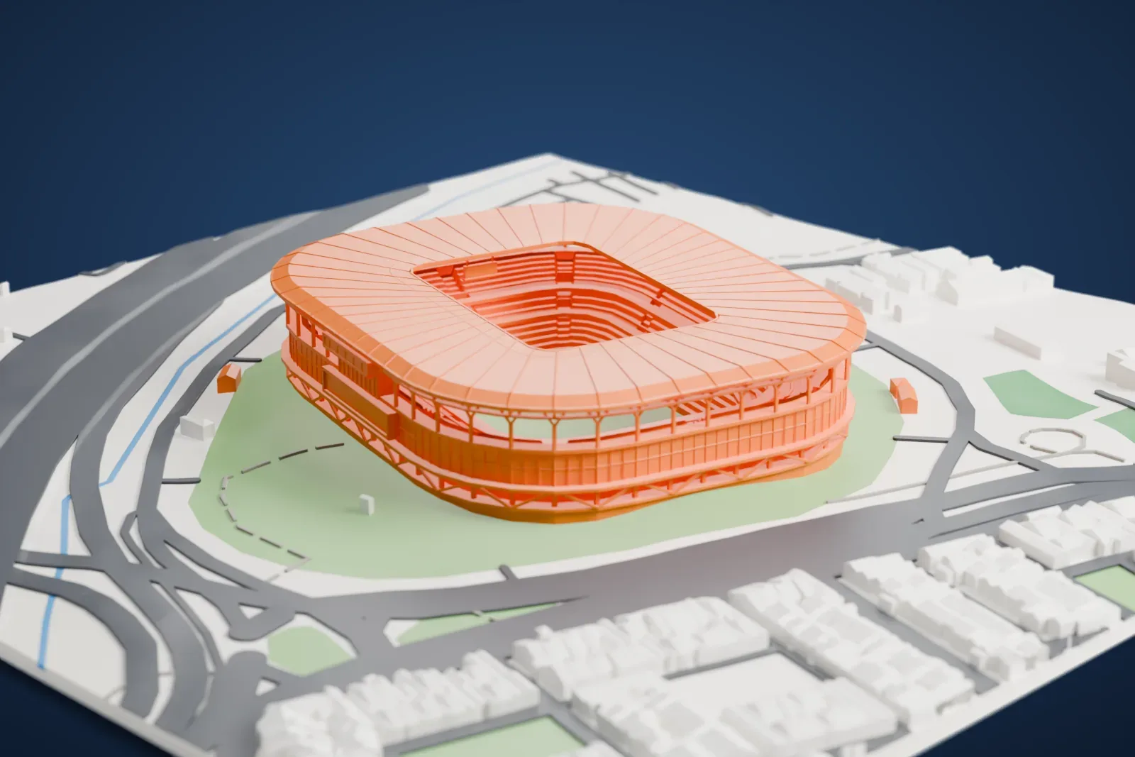 A white 3D print of Arena do Grêmio, a rounded stadium with a ribbed roof, on green grounds ringed by roads and low buildings.