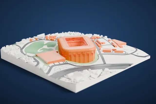 A white 3D print of Arena MRV, a rounded stadium with raised lettering on its facade, surrounded by houses, roads and green areas.