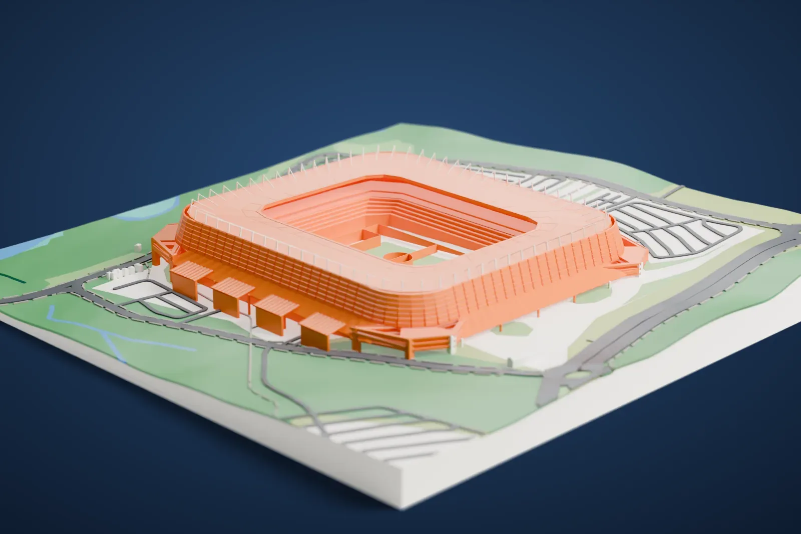 A white 3D print of Arena Pernambuco, the tiered seating bowl of a rounded-rectangle stadium, on open ground with roads and green patches.