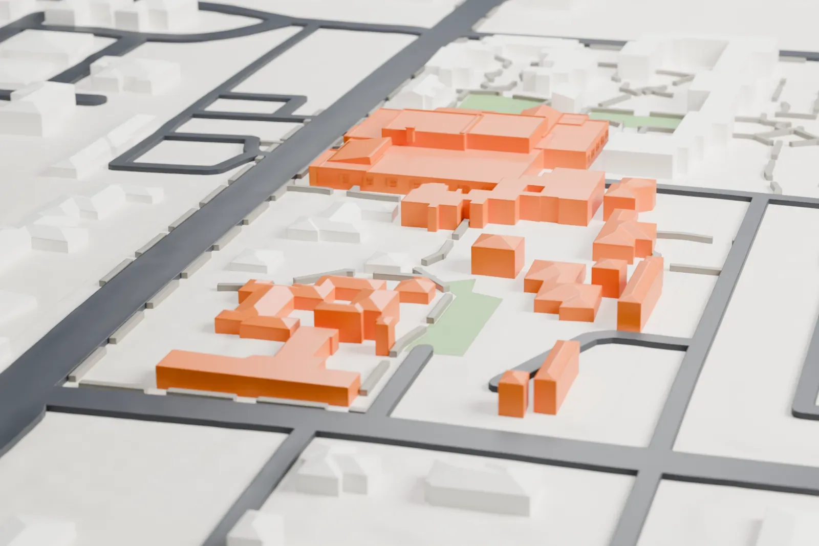 A white 3D print of the Arizona Inn, a low, wide cluster of connected buildings with several roofs, set among other buildings, small lawns and streets.