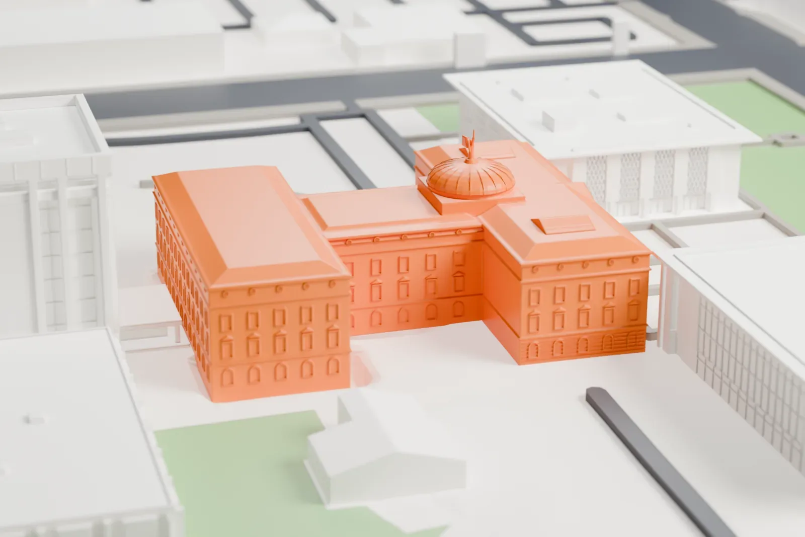 A white 3D print of the Arizona State Capitol with a ribbed dome and columned entrance, surrounded by buildings, streets, and patches of green space.