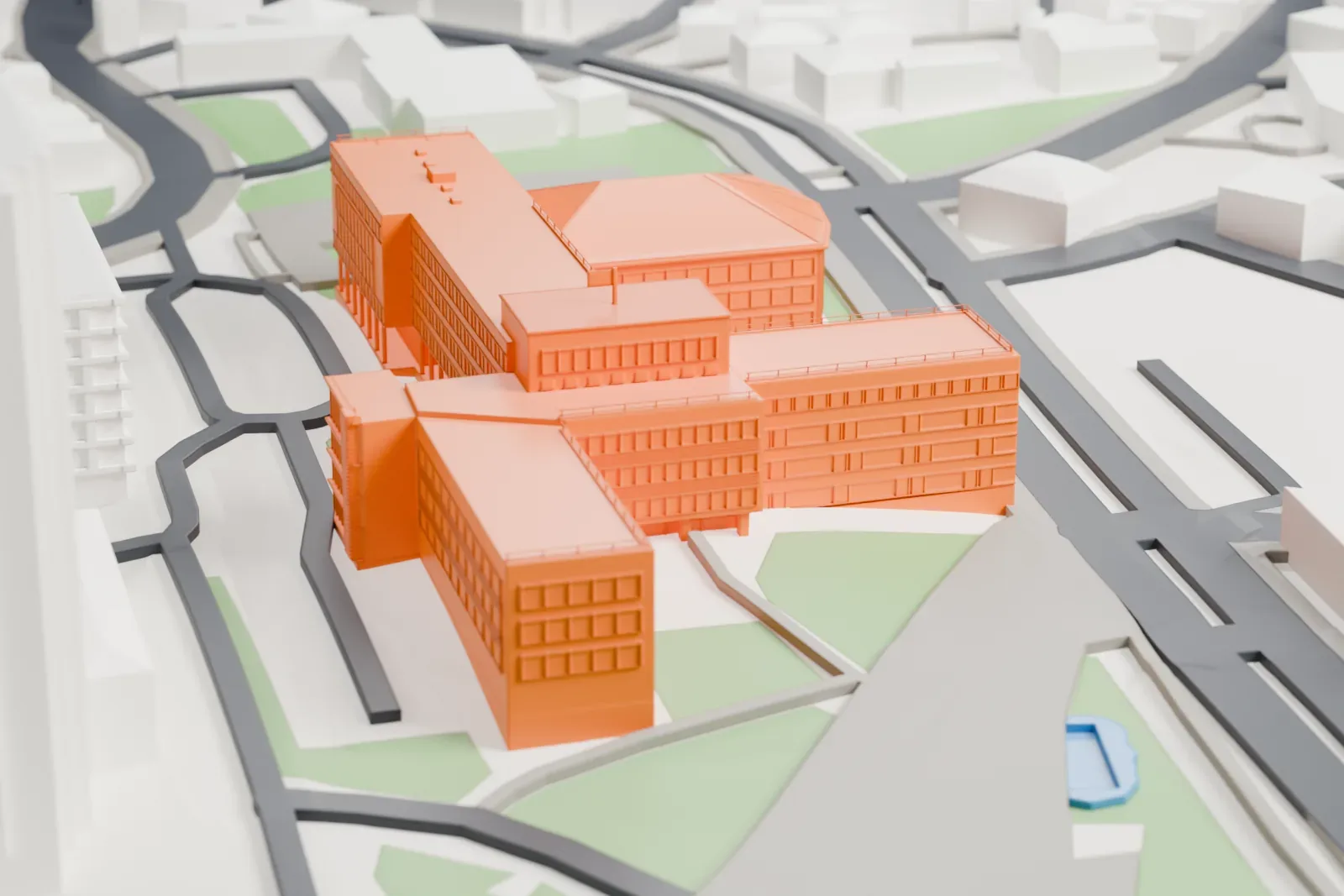 A white 3D print of the Assembly of Kosovo, with its ribbon windows and branching wings, surrounded by city buildings.