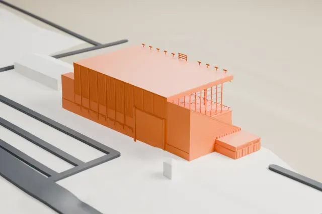 A white 3D print of the Assiniboia Downs Grandstand model in Winnipeg, with the streets around it.