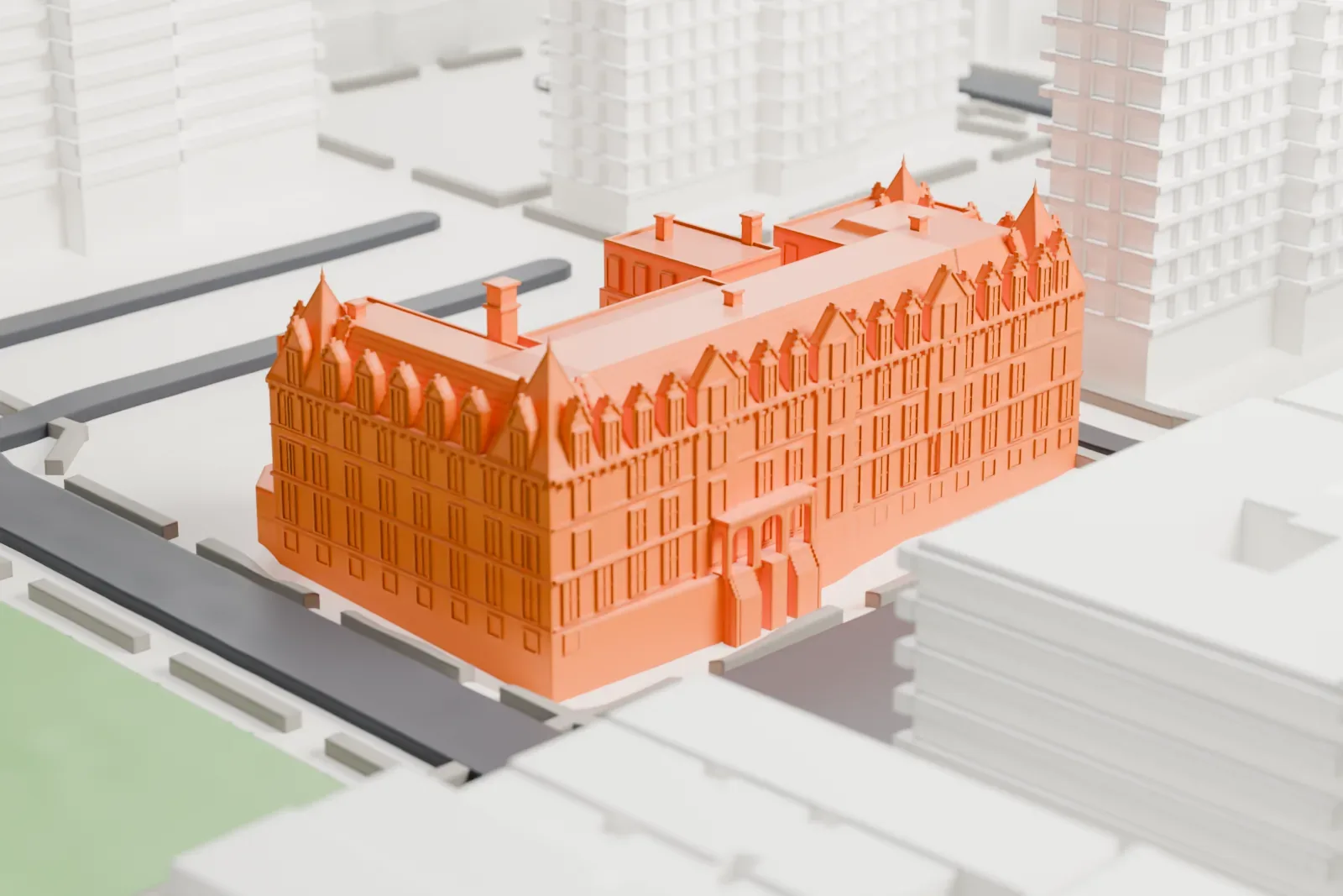 A white 3D print of the Association Residence Nursing Home, a large building with a gabled roofline and small turrets, beside a park and mid-rise buildings.