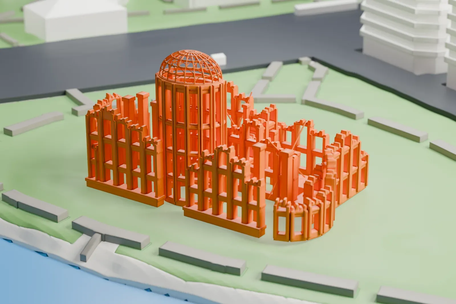 A white 3D print of the Atomic Bomb Dome with its open dome framework and broken walls, beside a river with park paths and nearby buildings.