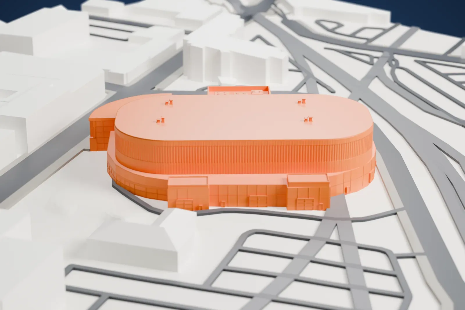 A white 3D print of Avenir Centre, an oval arena with a ribbed wall, a flat roof and a glass-fronted entrance, surrounded by streets and other buildings.