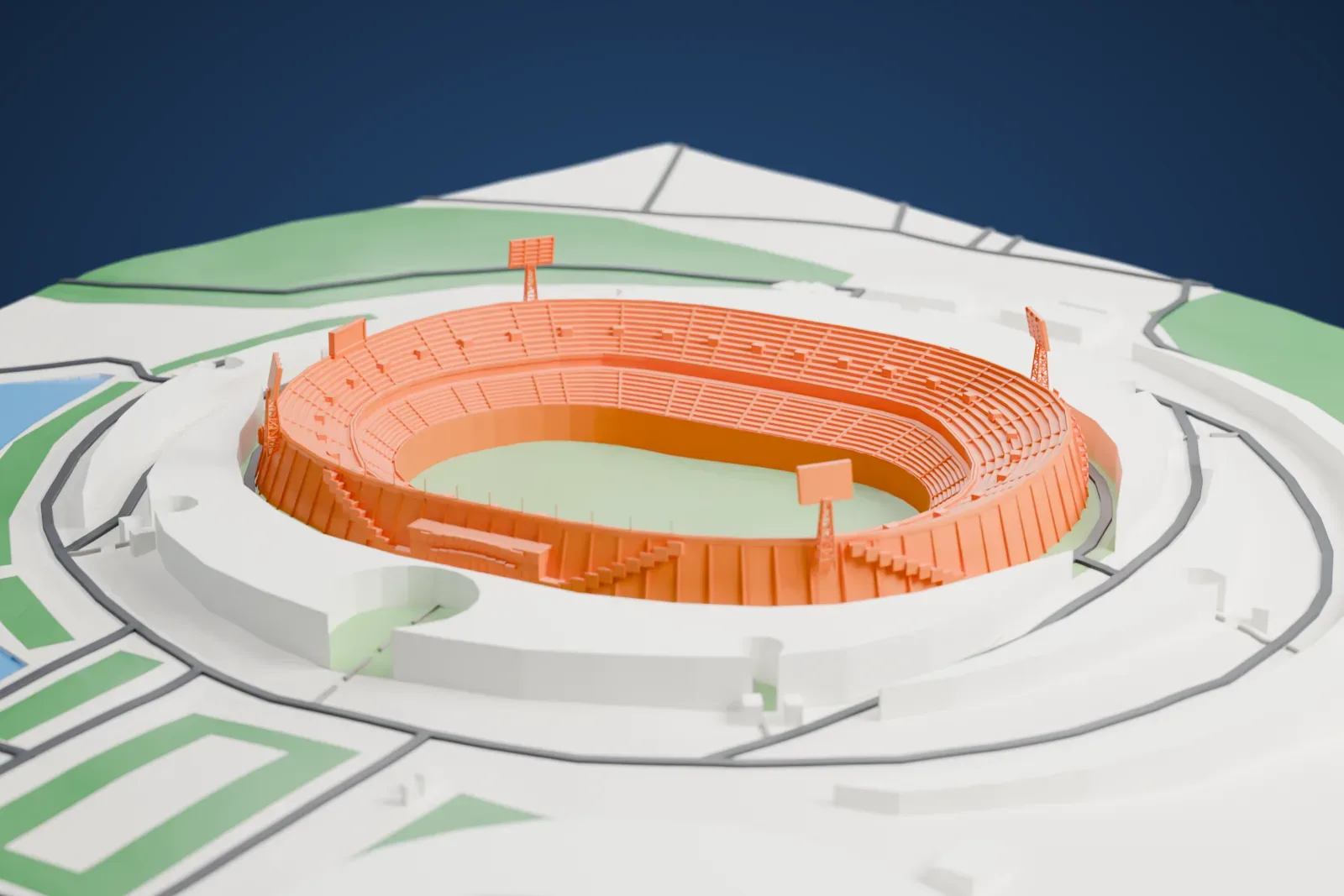 A white 3D print of Azadi Stadium, a roofless two-tier oval bowl with four lattice floodlight towers at its corners, among surrounding streets and buildings.