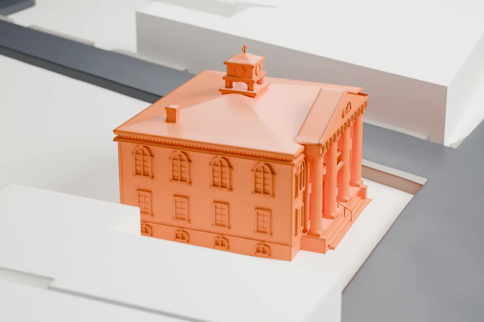 A white 3D print of Babylon Town Hall, a two-story building with a four-column portico and a small cupola on its hipped roof, among nearby streets and buildings.