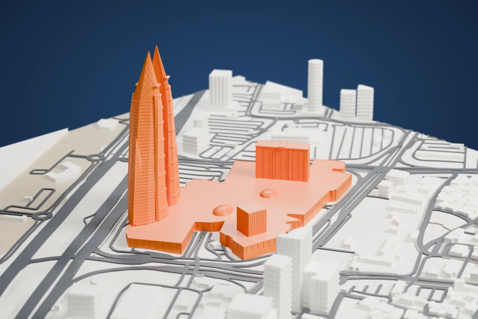 A white 3D print of the Bahrain World Trade Center, twin sail-shaped towers linked by three turbine bridges, among surrounding buildings.
