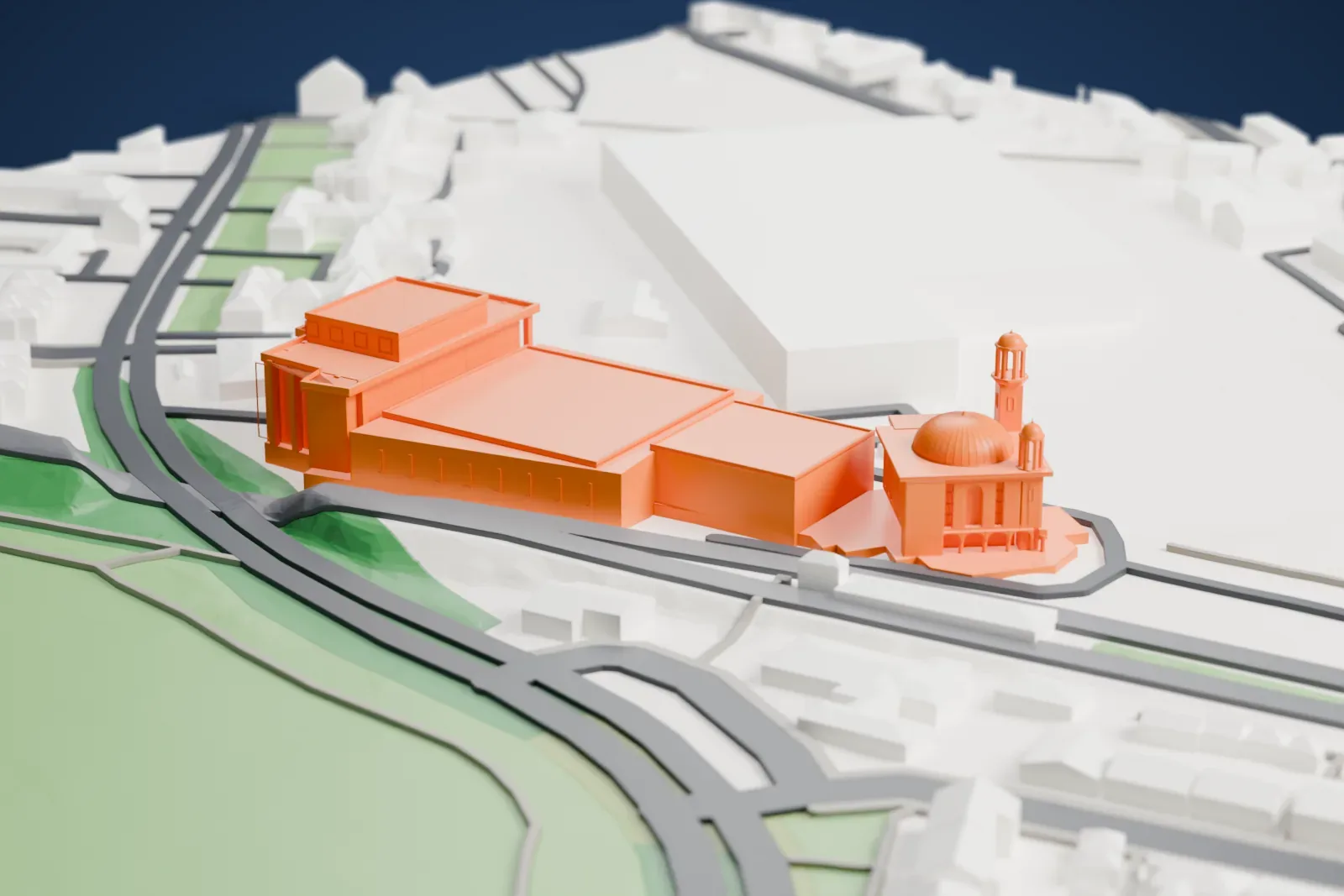 A white 3D print of the Baitul Futuh Mosque, a low, wide complex among the streets and buildings of Morden, London.