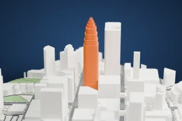 A white 3D print of the Bank of America Corporate Center, a tall ribbed tower with a stepped crown, rising above the surrounding city buildings.