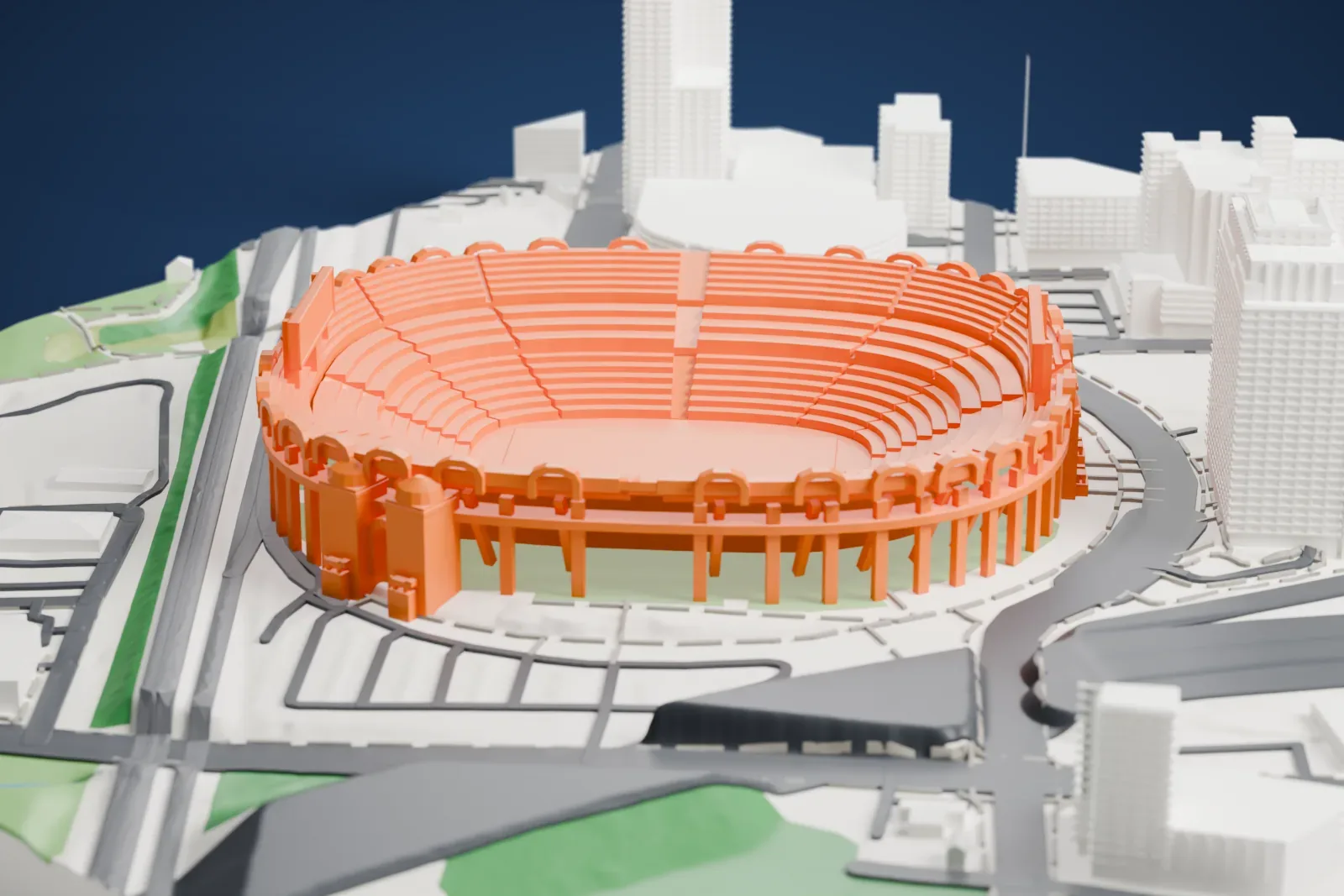 A white 3D print of Bank of America Stadium, an open bowl ringed with arches on tall columns, with domed entrance towers, surrounded by city buildings and roads.