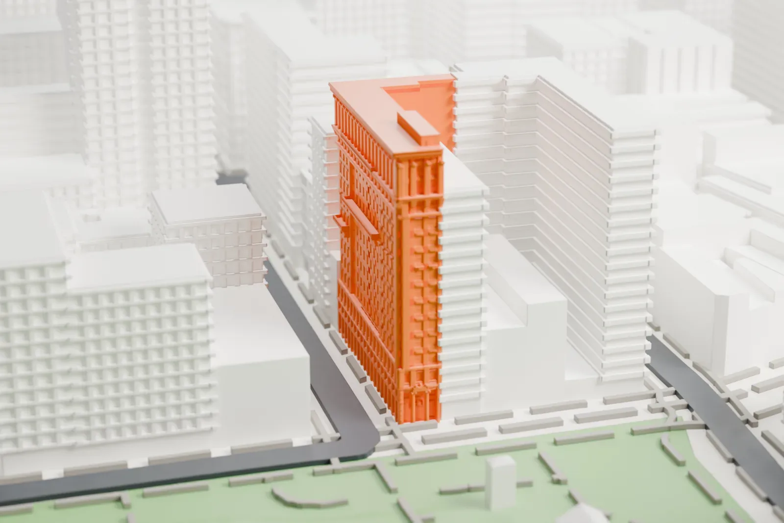 A white 3D print of the Bank of the Metropolis, an L-shaped tower with a carved cornice, standing beside the green of Union Square among dense buildings.